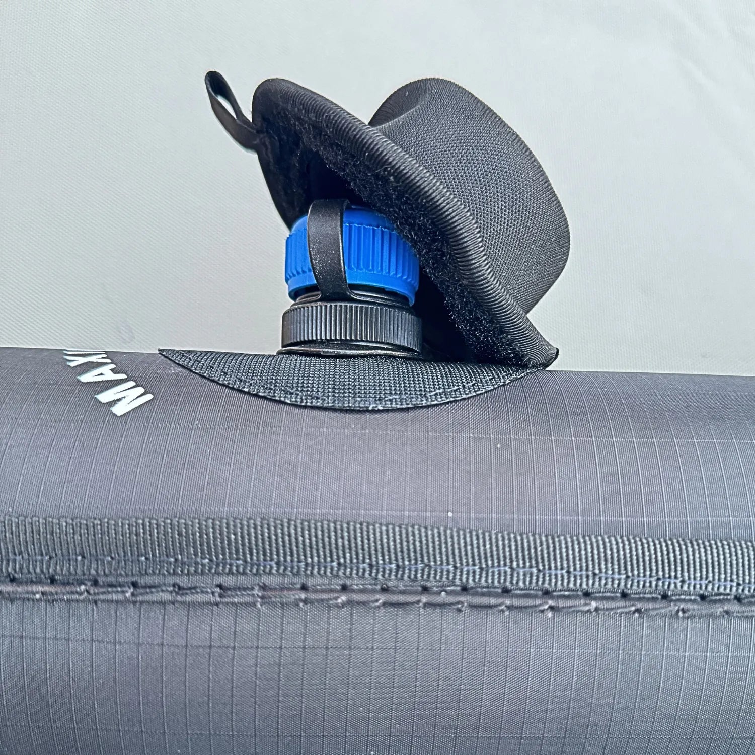 Single-point high-velocity inflation valve on the Sebba Shade, featuring the protective fabric hat and signature blue safety cap.