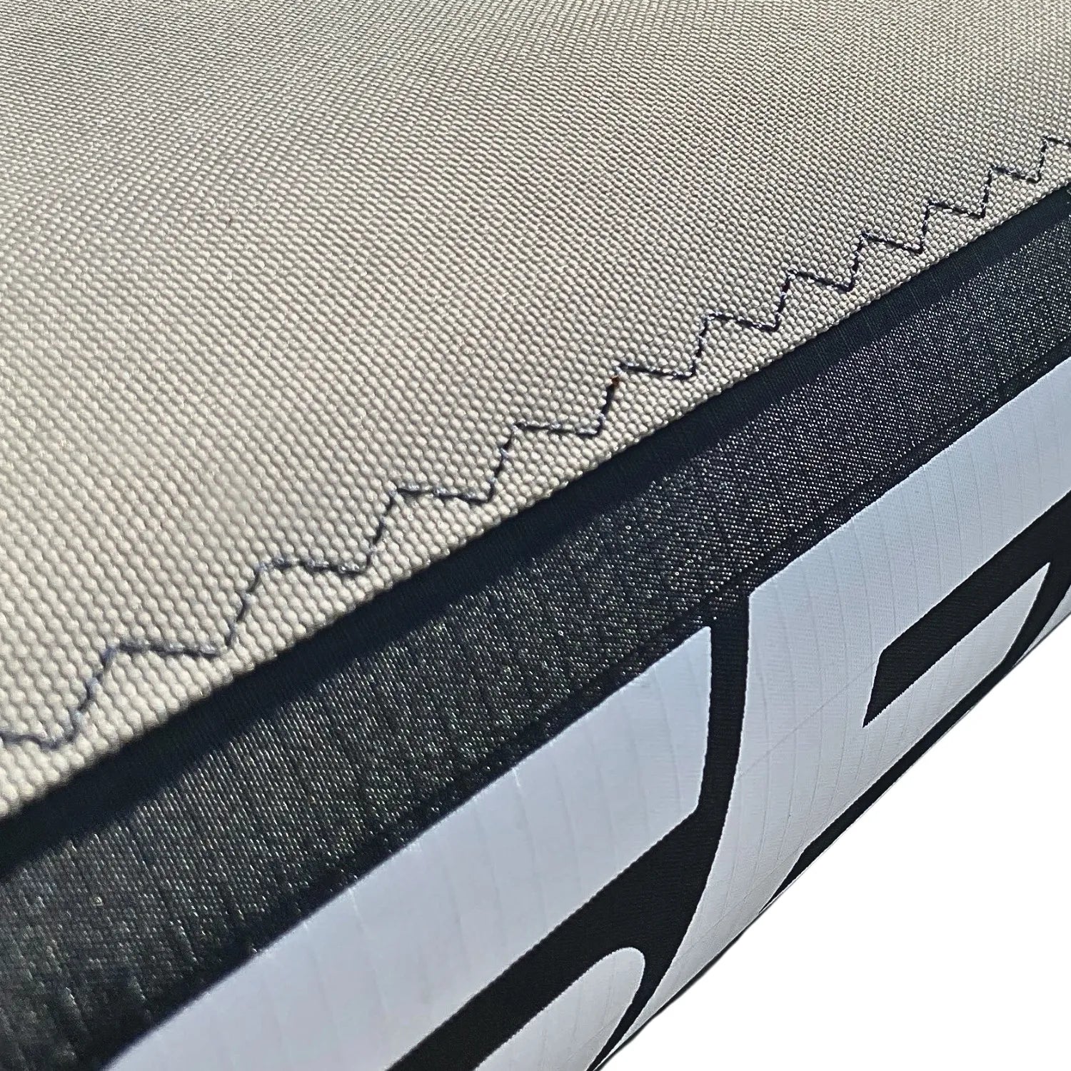 Macro view of high-density marine stitching fusing the Mach-Shield 45™ canopy to the AeroCasing™ airframe, featuring the Sebba Shade logo.