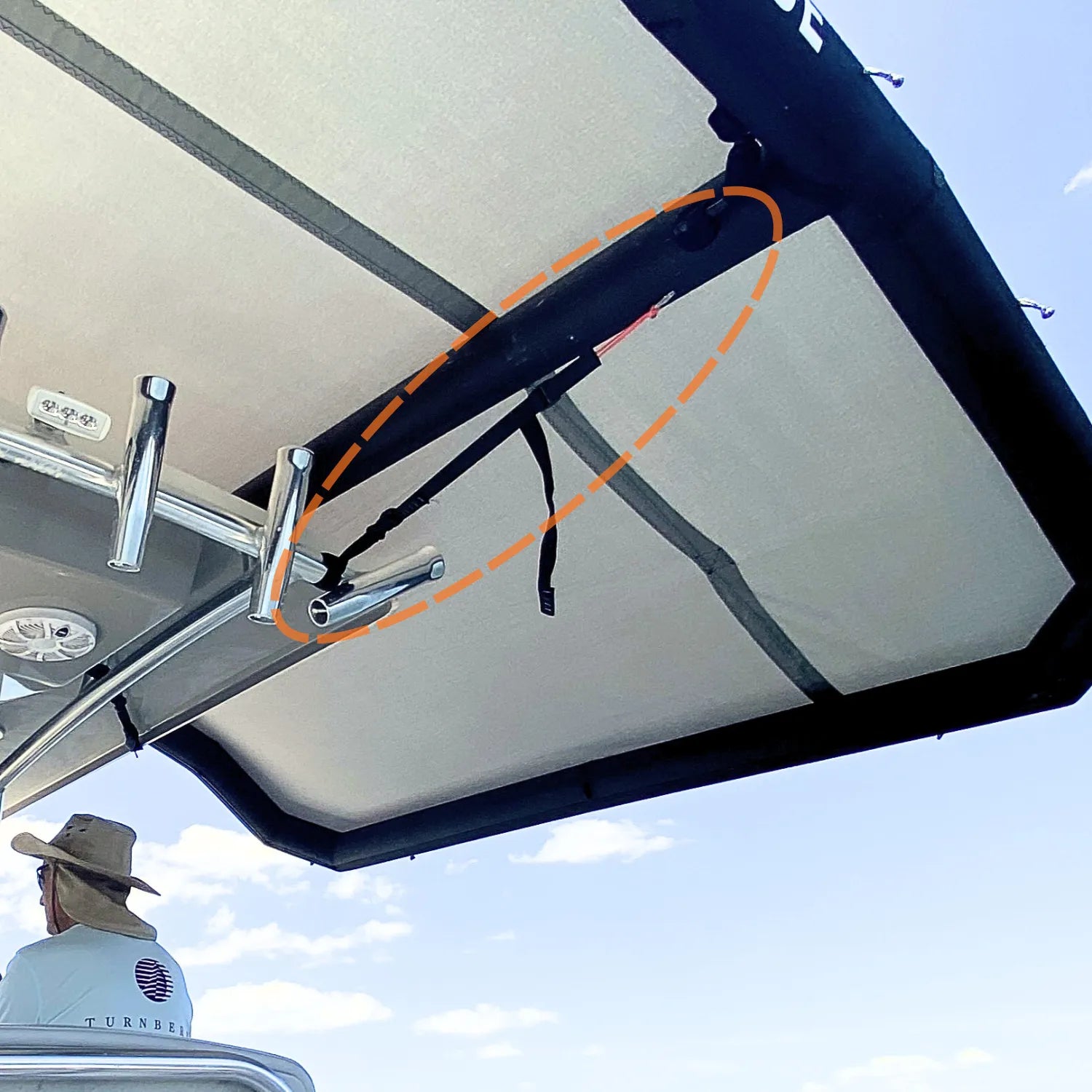 Close-up of the Sebba Shade zero-trace fastening system. Heavy-duty polyester webbing securely loops around a boat's metal tower frame without the use of metal brackets, demonstrating a secure, drill-free connection.