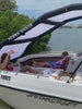 Family relaxing on a deck boat under a Sebba Shade 6x9, demonstrating the extra headroom, and safety of the soft inflatable frame and laboratory-certified UPF 2000+ protection.