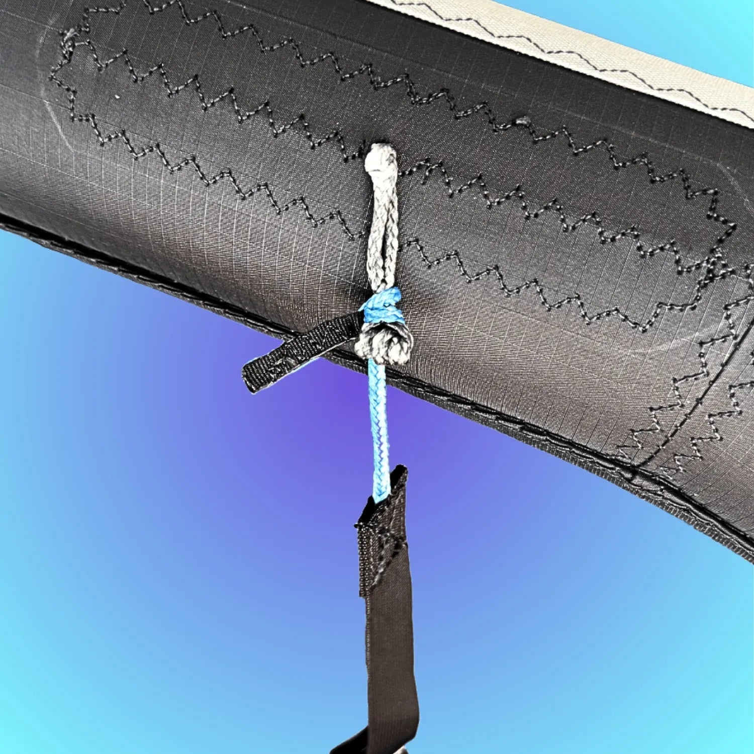 A 2-foot adjustable rigging strap with blue-coded Dyneema® ends secured to an integrated gray pigtail for close-quarter boat rigging.