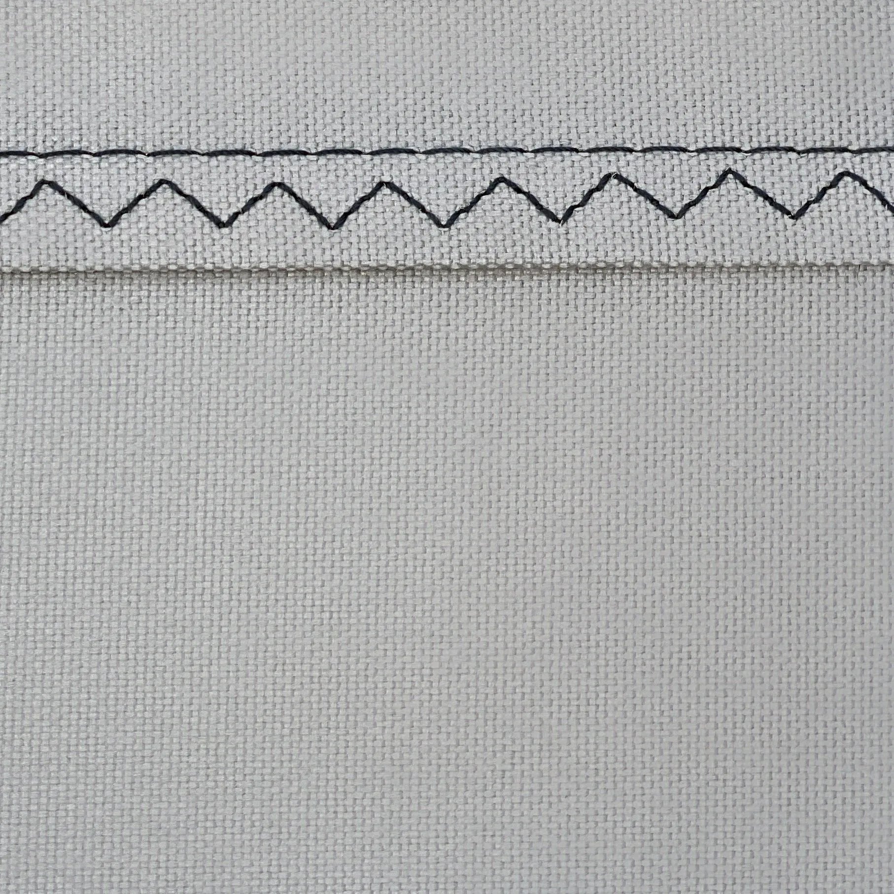 A high-magnification macro photograph of the Mach-Shield™ 45 technical textile. The image showcases the ultra-dense 600D Oxford weave and 280 GSM fabric weight, illustrating the physical barrier responsible for a laboratory-certified UPF 2000+ rating and 99.95% solar radiation blockage on the water.